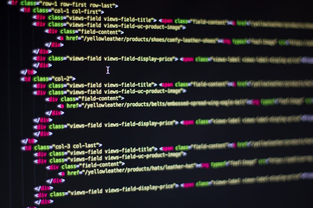 pexels-photo-270632 Detailed close-up of HTML code on a computer monitor, showcasing web development.